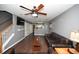 Spacious living room with a ceiling fan, gray walls, dark floors and a staircase leading to the upper level at 100 Barnacle Ln. # S-4, Little River, SC 29566