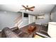 Cozy living room features stairs, wood-look flooring, gray walls, and a ceiling fan at 100 Barnacle Ln. # S-4, Little River, SC 29566
