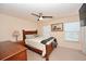 Comfortable main bedroom with ceiling fan, a wood bed frame, and neutral tones at 100 Barnacle Ln. # S-4, Little River, SC 29566