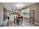 Cozy dining area with wood floors, pendant lights, and a view of the modern kitchen at 1390 Highway 129, Galivants Ferry, SC 29544