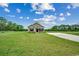 Scenic view of a home set on a large grassy lot with trees in the background at 1390 Highway 129, Galivants Ferry, SC 29544