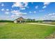 A well-maintained home with a sprawling lawn under a partly cloudy blue sky at 1390 Highway 129, Galivants Ferry, SC 29544