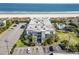 Aerial view of a beachfront complex with a pool and parking area, offering easy access to the sandy beach at 1501 S Waccamaw Dr. # 3-L, Murrells Inlet, SC 29576