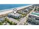 Aerial view of the building, beach, and surrounding neighborhood with marker on property at 1501 S Waccamaw Dr. # 3-L, Murrells Inlet, SC 29576