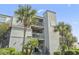 Multi-story condo building exterior with stairs leading to the entrance and outdoor balconies at 1501 S Waccamaw Dr. # 3-L, Murrells Inlet, SC 29576