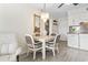 A dining area features a table, four chairs, chandelier, and a mirror at 1501 S Waccamaw Dr. # 3-L, Murrells Inlet, SC 29576