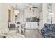 Cozy living area featuring coastal-themed decor, a dining table, and an open kitchen at 1501 S Waccamaw Dr. # 3-L, Murrells Inlet, SC 29576