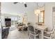 The living room features a fireplace, sofa, chairs, table, chandelier, and access to a balcony at 1501 S Waccamaw Dr. # 3-L, Murrells Inlet, SC 29576
