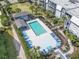 Aerial view of the pool and surrounding area with palm trees and lounge chairs at 1501 S Waccamaw Dr. # 3-L, Murrells Inlet, SC 29576