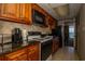 A well-appointed kitchen featuring wooden cabinets, granite countertops and a modern stainless steel microwave at 1501 South Ocean Blvd. # 738, Myrtle Beach, SC 29577
