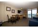 Comfortable living room area featuring dining table with chairs, side chair, and a view from the balcony at 1501 South Ocean Blvd. # 738, Myrtle Beach, SC 29577