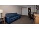 A cozy living room area with a blue couch, wood table, and a dining table with chairs at 1501 South Ocean Blvd. # 738, Myrtle Beach, SC 29577