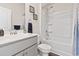 Bright bathroom features an integrated sink, a shower with tub, and a neutral color palette at 1612 Cosmos Lane, Myrtle Beach, SC 29577