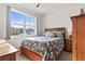 Bright bedroom with natural light boasts a large window and a comfortable bed with decorative pillows at 1612 Cosmos Lane, Myrtle Beach, SC 29577