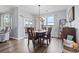 Bright dining room features wood floors, a stylish light fixture, and sliding glass doors to the outdoor space at 1612 Cosmos Lane, Myrtle Beach, SC 29577