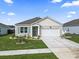 Charming one-story home with a well-manicured lawn and a two-car garage on a sunny day at 1612 Cosmos Lane, Myrtle Beach, SC 29577