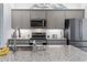 Stylish kitchen featuring gray cabinets, stainless steel appliances, and a granite countertop at 1612 Cosmos Lane, Myrtle Beach, SC 29577