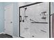 This walk-in shower features a marble tile surround, modern fixtures, built-in shelving, and a glass enclosure at 1612 Cosmos Lane, Myrtle Beach, SC 29577