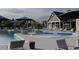 Community pool with lounge chairs, umbrellas, BBQ grill, and tables for entertaining at 231 Broughton Dr., Myrtle Beach, SC 29579