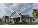 Charming home featuring classic architecture, a welcoming front porch, and professionally landscaped yard at 231 Broughton Dr., Myrtle Beach, SC 29579