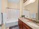 Well-lit bathroom with a granite countertop, a bathtub with shower, and decorative accents at 2790 Howard Ave. # D, Myrtle Beach, SC 29577