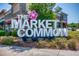 An eye-level photograph of the Market Common sign, flanked by shrubs in front of the shopping center at 2790 Howard Ave. # D, Myrtle Beach, SC 29577