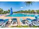 Resort-style pool area with lounge chairs, umbrellas, and palm trees, offering a relaxing vacation atmosphere at 2790 Howard Ave. # D, Myrtle Beach, SC 29577