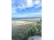 Expansive beach view featuring a pier, lush dunes, and a clear blue sky with sailboats on the shore at 2904 Lunar Ct., Myrtle Beach, SC 29577