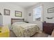Comfortable bedroom featuring a wooden frame bed, complemented by a matching nightstand and a large window at 2904 Lunar Ct., Myrtle Beach, SC 29577