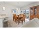 Light-filled dining area featuring a wooden table, view to back yard and modern lighting at 2904 Lunar Ct., Myrtle Beach, SC 29577