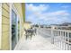 Outdoor deck with a dining table and seating, overlooking a tranquil waterway at 308 36Th Ave. N, North Myrtle Beach, SC 29582