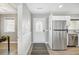Home entryway featuring a white door and view of stainless steel appliances and an open room at 308 36Th Ave. N, North Myrtle Beach, SC 29582