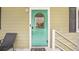 The turquoise front door has decorative glass and a brushed silver handle, complete with seashell decor at 308 36Th Ave. N, North Myrtle Beach, SC 29582