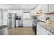 Bright white kitchen featuring stainless steel appliances and granite countertops, and white cabinets at 308 36Th Ave. N, North Myrtle Beach, SC 29582