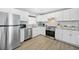 Modern kitchen with stainless appliances, granite countertops, white cabinets and tile backsplash at 308 36Th Ave. N, North Myrtle Beach, SC 29582