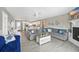 Spacious living room with gray couches, a decorative fireplace, and an open layout to the kitchen at 308 36Th Ave. N, North Myrtle Beach, SC 29582