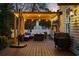 Outdoor seating area on wooden deck with umbrella, grill, and string lights at 3255 Gervais Ln., Myrtle Beach, SC 29588