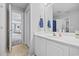 Neutral bathroom with a white vanity, framed mirror, and tiled flooring at 3255 Gervais Ln., Myrtle Beach, SC 29588