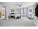 Bright bedroom features carpet, ceiling fan, and large windows with blue curtains at 3255 Gervais Ln., Myrtle Beach, SC 29588