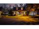 Evening view of a charming home with detached garage and well-maintained landscaping at 3255 Gervais Ln., Myrtle Beach, SC 29588