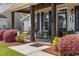 Inviting front porch with rocking chairs, decorative plants, and wood columns at 3255 Gervais Ln., Myrtle Beach, SC 29588