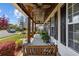 Covered front porch featuring a swing, potted plants, and wooden columns at 3255 Gervais Ln., Myrtle Beach, SC 29588