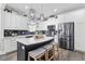 Stylish kitchen featuring white cabinets, a dark backsplash, and an island with seating at 3255 Gervais Ln., Myrtle Beach, SC 29588