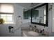 Bathroom featuring modern vanity, large mirror, and window allowing natural light at 3904 Birchwood St., North Myrtle Beach, SC 29582