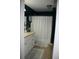 Cozy bathroom featuring white cabinetry, a framed mirror, and a shower at 3904 Birchwood St., North Myrtle Beach, SC 29582