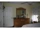 Bedroom featuring wooden dresser with mirror and floral curtains allowing ample natural light at 3904 Birchwood St., North Myrtle Beach, SC 29582