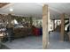 Covered carport with wood beams, firewood storage, and ample space for parking and other uses at 3904 Birchwood St., North Myrtle Beach, SC 29582