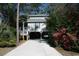 Charming elevated beach home with covered parking, manicured landscaping, and a welcoming front porch at 3904 Birchwood St., North Myrtle Beach, SC 29582