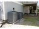Exterior view showcasing HVAC units, an outdoor shower, and the home's siding at 3904 Birchwood St., North Myrtle Beach, SC 29582