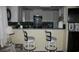 Charming kitchen featuring white cabinets, a breakfast bar, and modern appliances at 3904 Birchwood St., North Myrtle Beach, SC 29582
